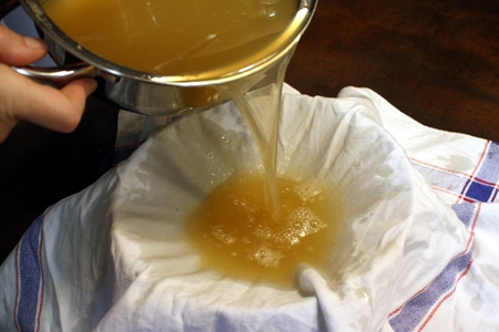 Straining the broth through a thin cloth